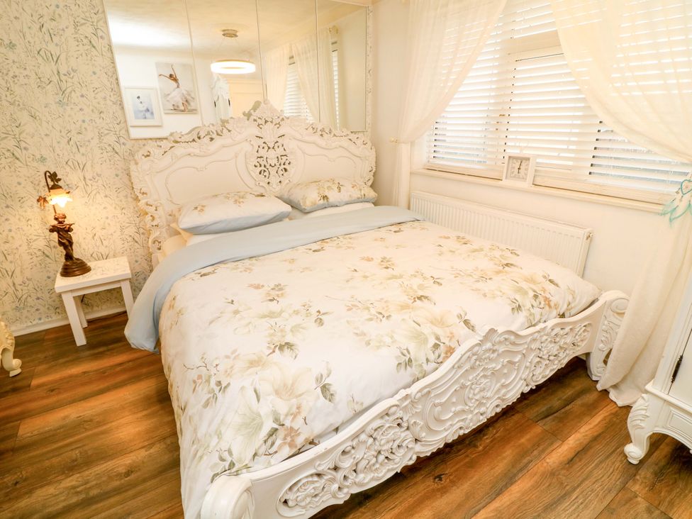 A bedroom with a bed and bedside table at 12 Wyndham Road in Loughborough