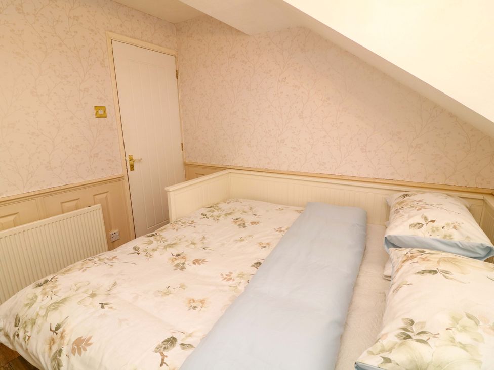 A bedroom with a bed and a door at 12 Wyndham Road in Loughborough