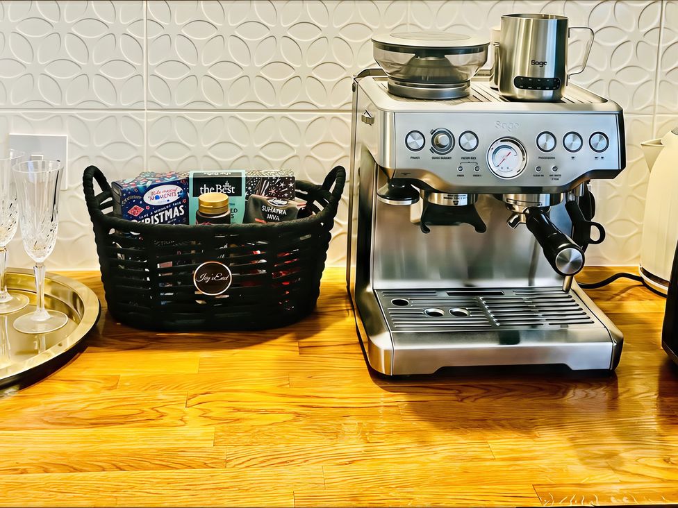 A coffee machine and a basket on a countertop at Ivy's End in Loughborough