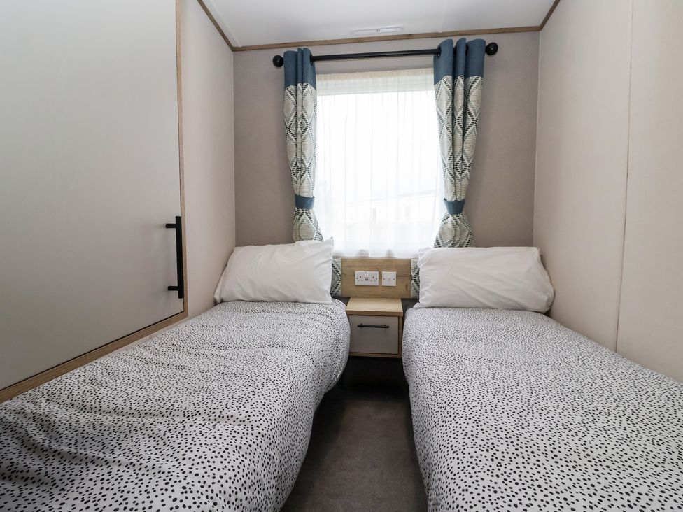 A bedroom with two beds and a window at The Driftwood near High Skirlington