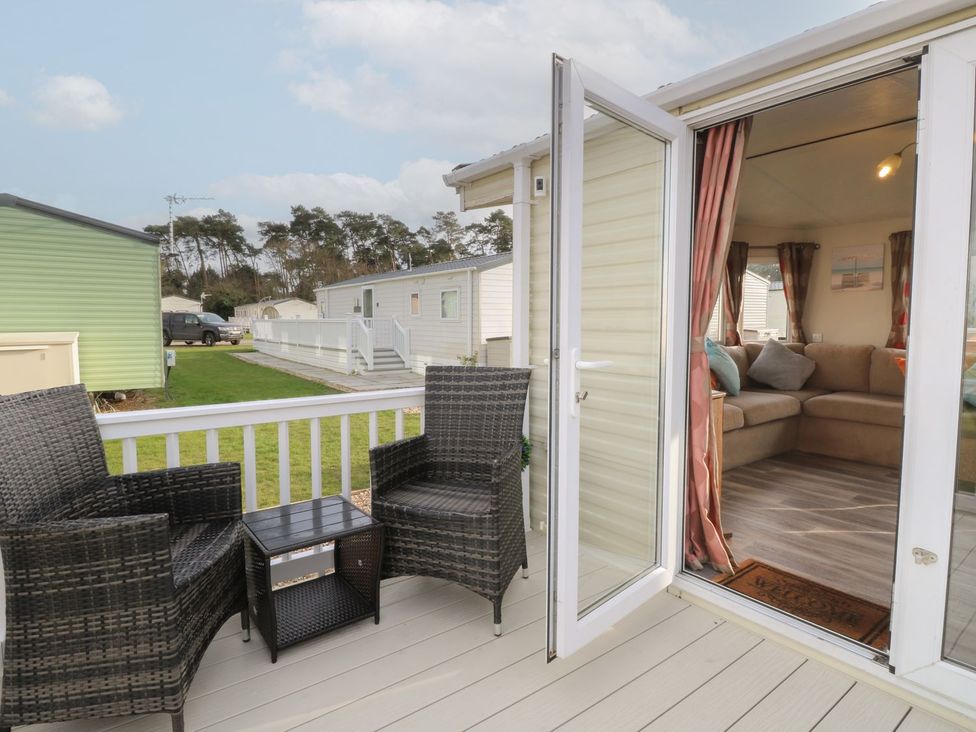 A patio area with chairs and a table at 46 Foxburrow Hang in Great Yarmouth