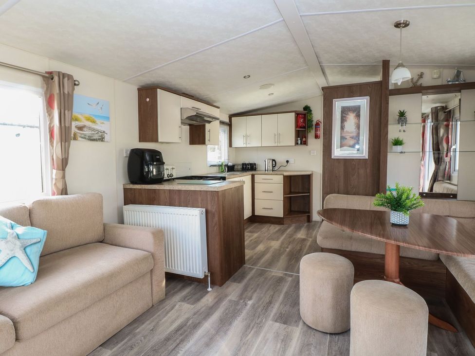 A living room with a kitchen and dining area at 46 Foxburrow Hang in Great Yarmouth