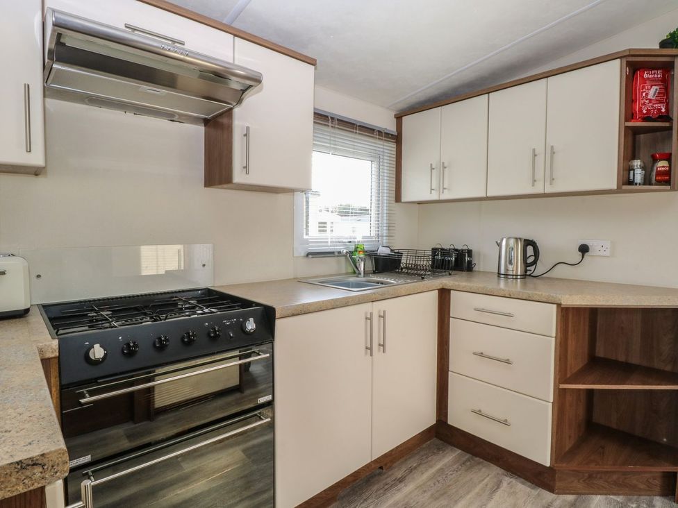 A kitchen with a stove and sink at 46 Foxburrow Hang in Great Yarmouth