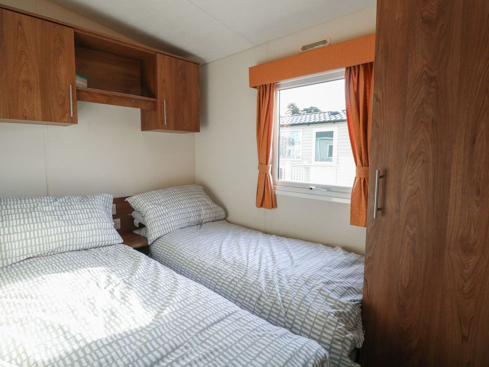 A bedroom with two beds and a window at 46 Foxburrow Hang in Great Yarmouth