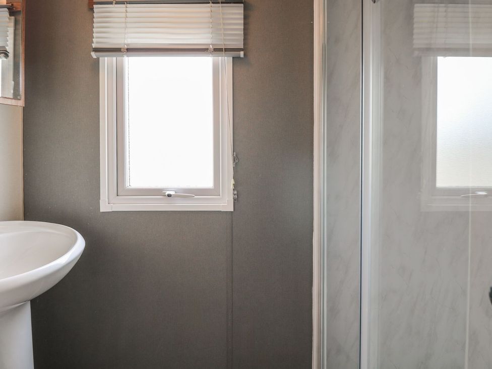 A bathroom featuring a sink, shower and window at 46 Foxburrow Hang in Great Yarmouth