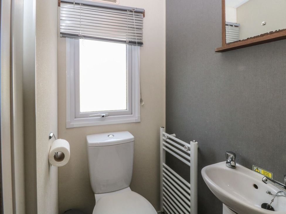 A bathroom with a toilet and sink at 46 Foxburrow Hang in Great Yarmouth