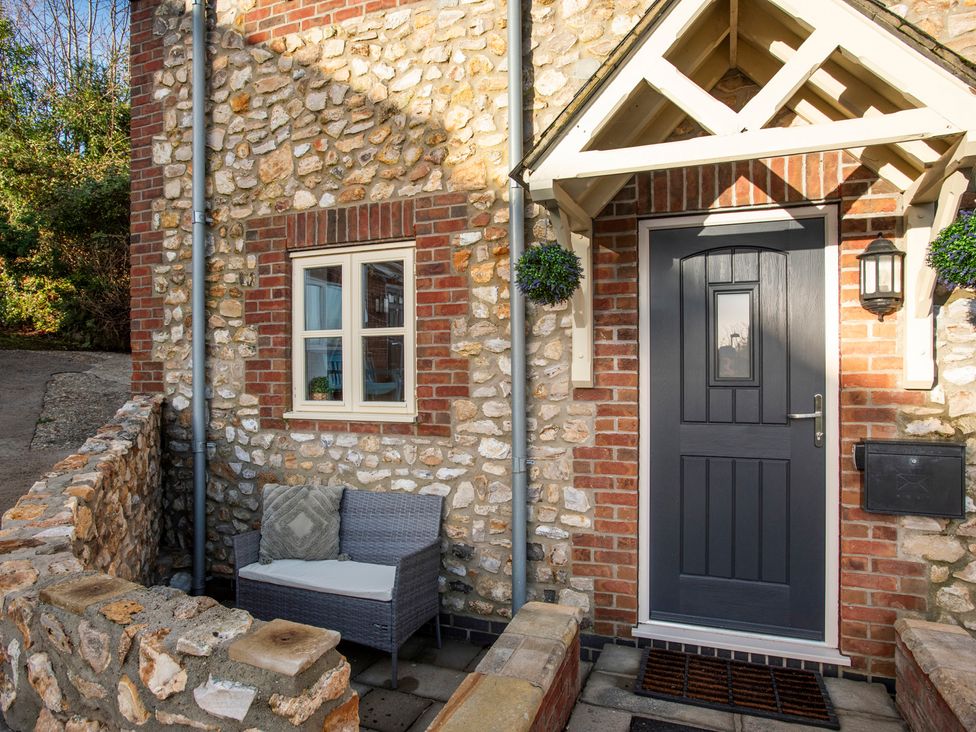 An entrance view with a bench and door at The Old Boat House Lyme Regis