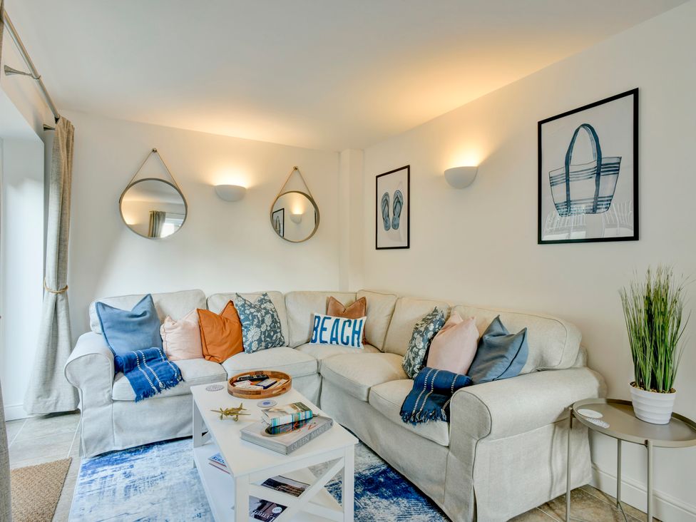 A living room with a sofa and coffee table at The Old Boat House Lyme Regis