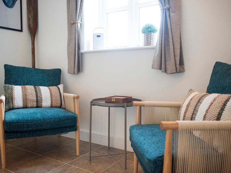A snug with two chairs and a side table at The Old Boat House Lyme Regis