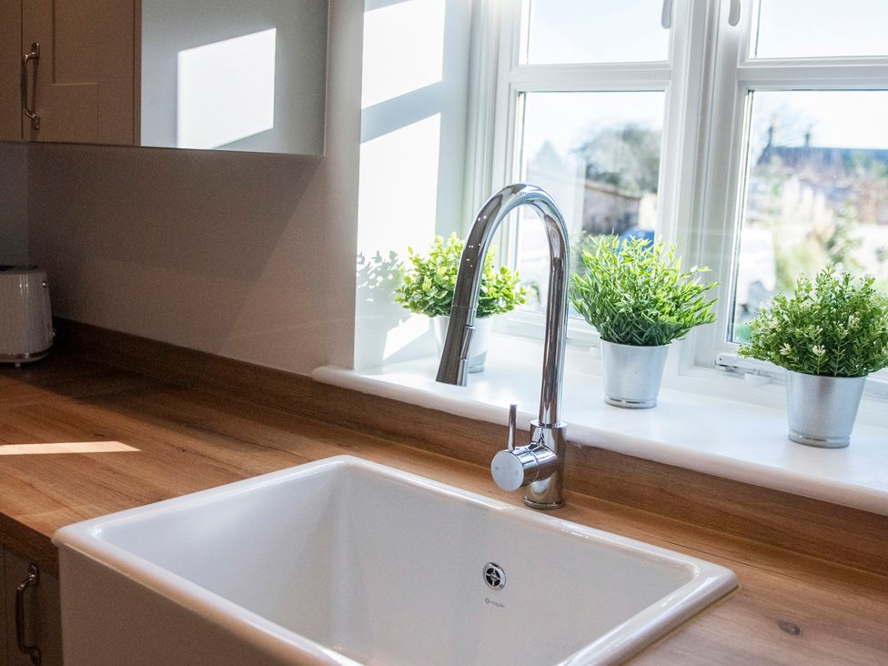 A kitchen with a sink and faucet at The Old Boat House Lyme Regis