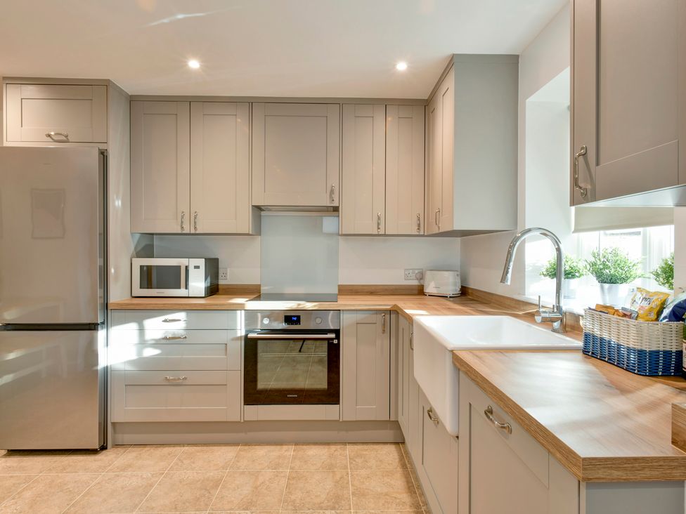 A kitchen with appliances and cabinets at The Old Boat House in Lyme Regis