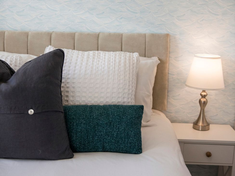 A bedroom with a bed and pillows at The Old Boat House in Lyme Regis