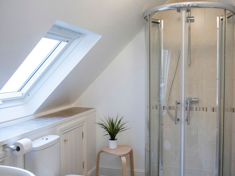 A bathroom with a shower and sink at The Old Boat House in Lyme Regis