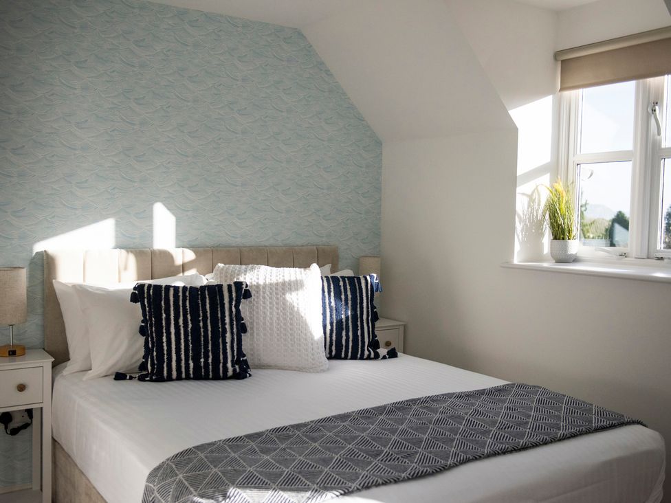 A bedroom with a bed and pillows at The Old Boat House in Lyme Regis