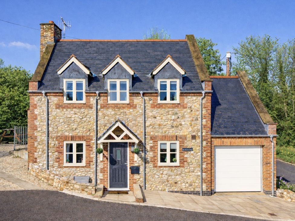 A house with a stone exterior and garage at The Old Boat House in Lyme Regis