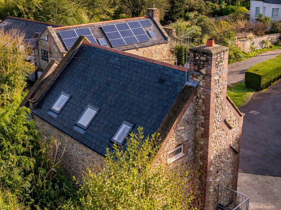 A roof with solar panels and a chimney in an outdoor area at The Old Boat House Lyme Regis