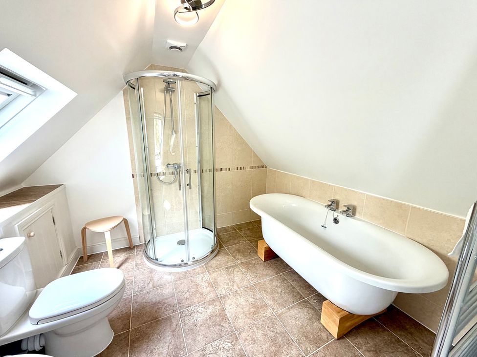 A bathroom with a shower and bathtub at The Old Boat House in Lyme Regis