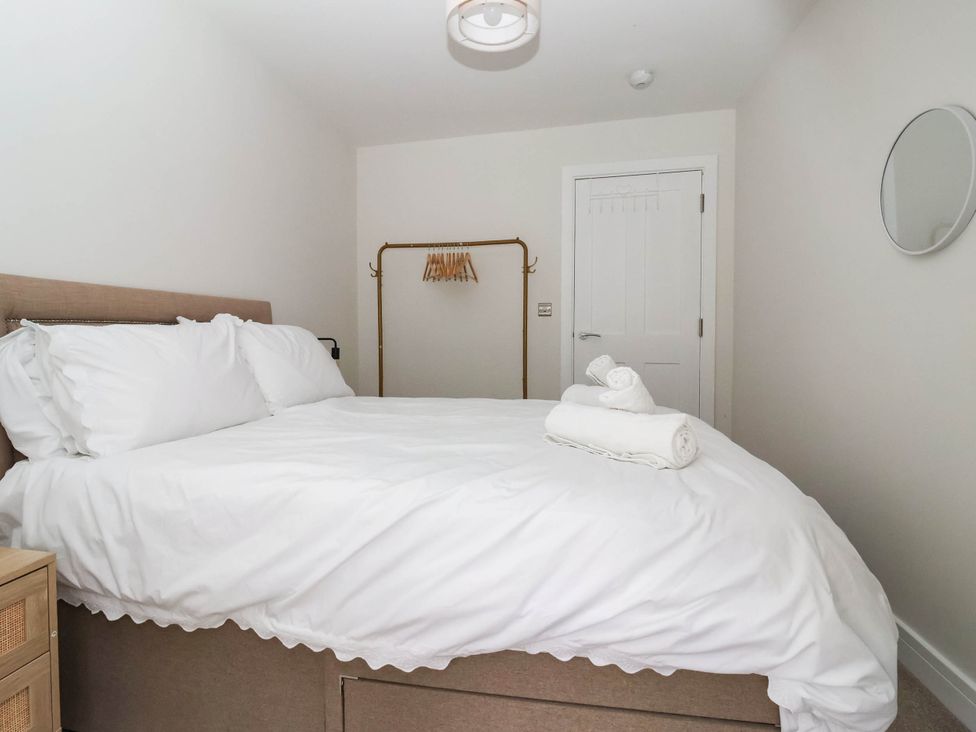 A bedroom with a bed and towels at The Old Bakehouse in 
