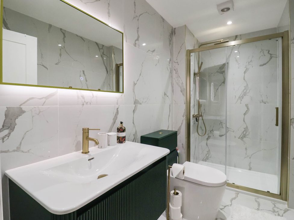 A bathroom with a shower and sink at The Old Bakehouse