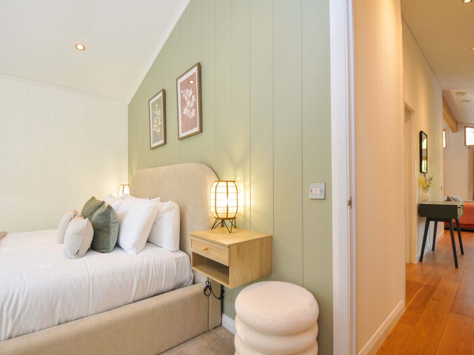 A bedroom with a bed and bedside table at 6 Stonerush Valley in Looe