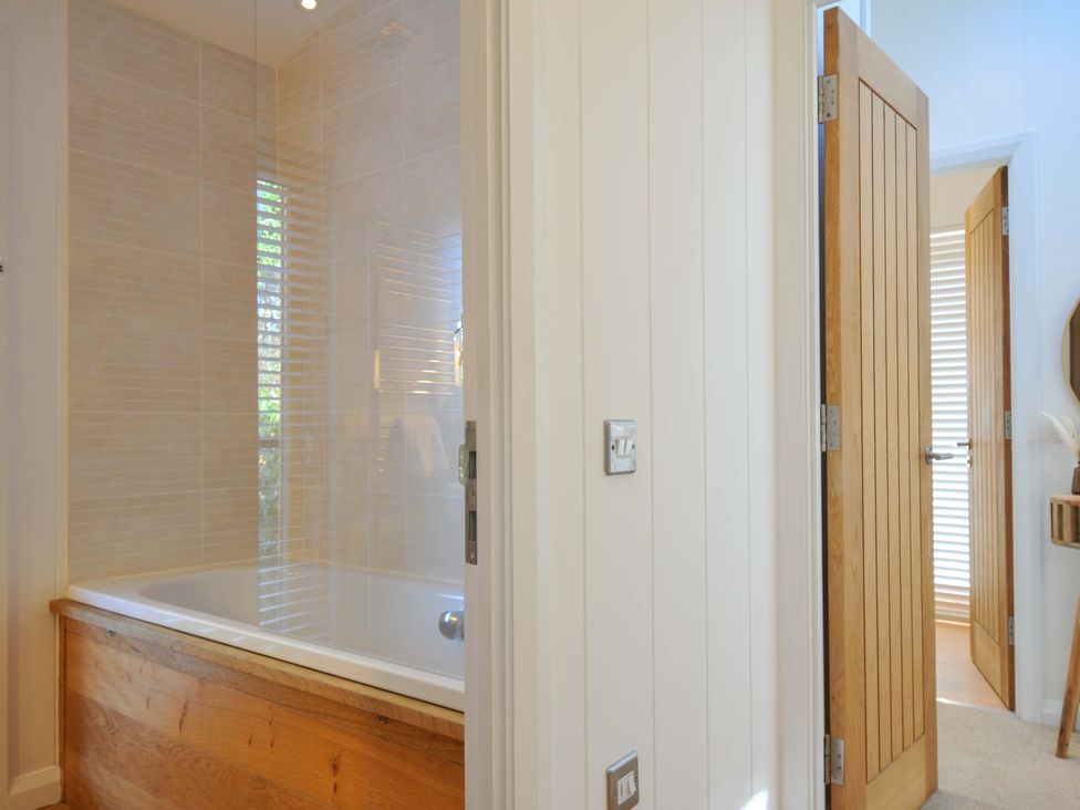 A bathroom featuring a bathtub and shower at 6 Stonerush Valley Looe