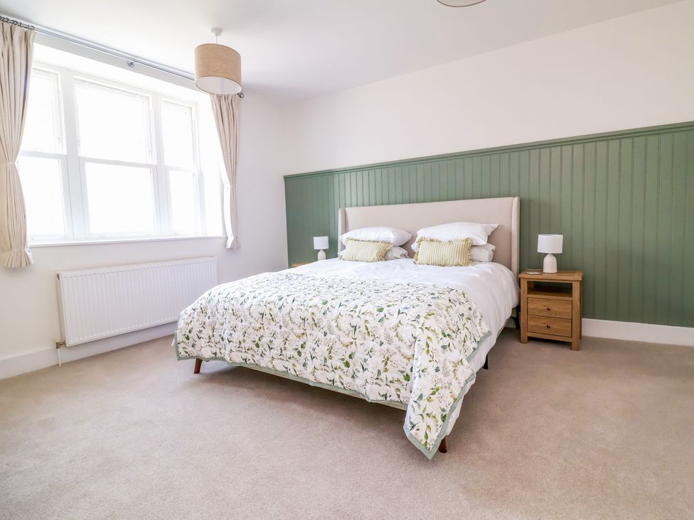 A bedroom with a bed and nightstand at The Old Bank Flat in North Tawton