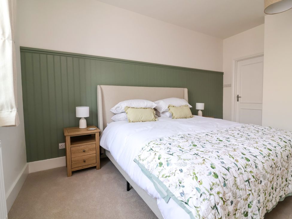 A bedroom with a bed and bedside table at The Old Bank Flat in North Tawton