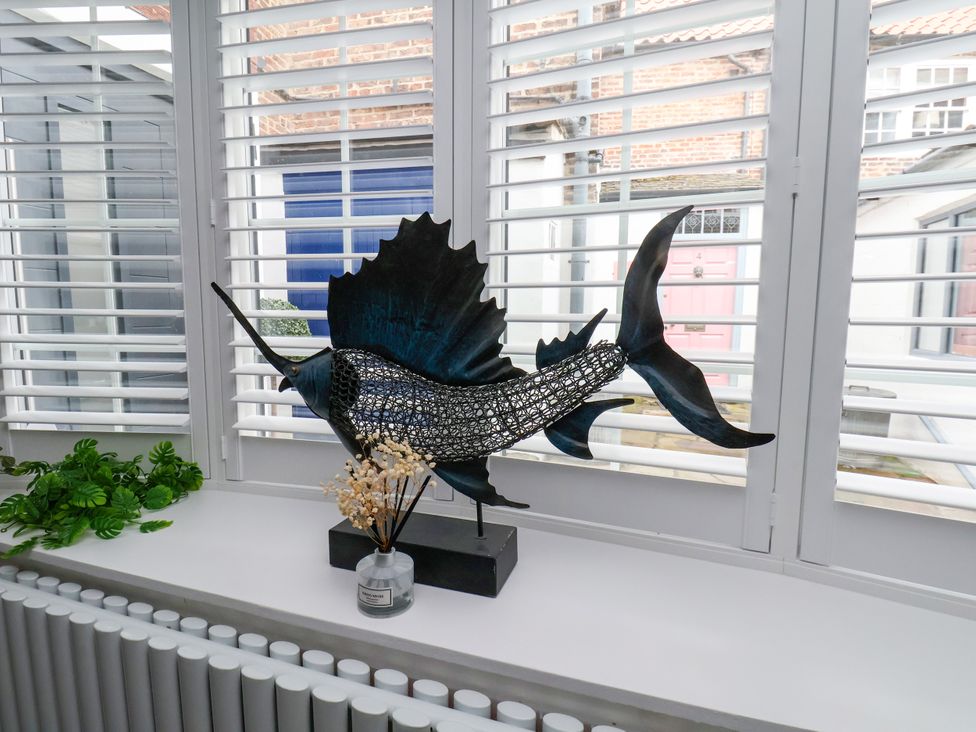 A decorative fish sculpture on a windowsill at OG's House in Whitby