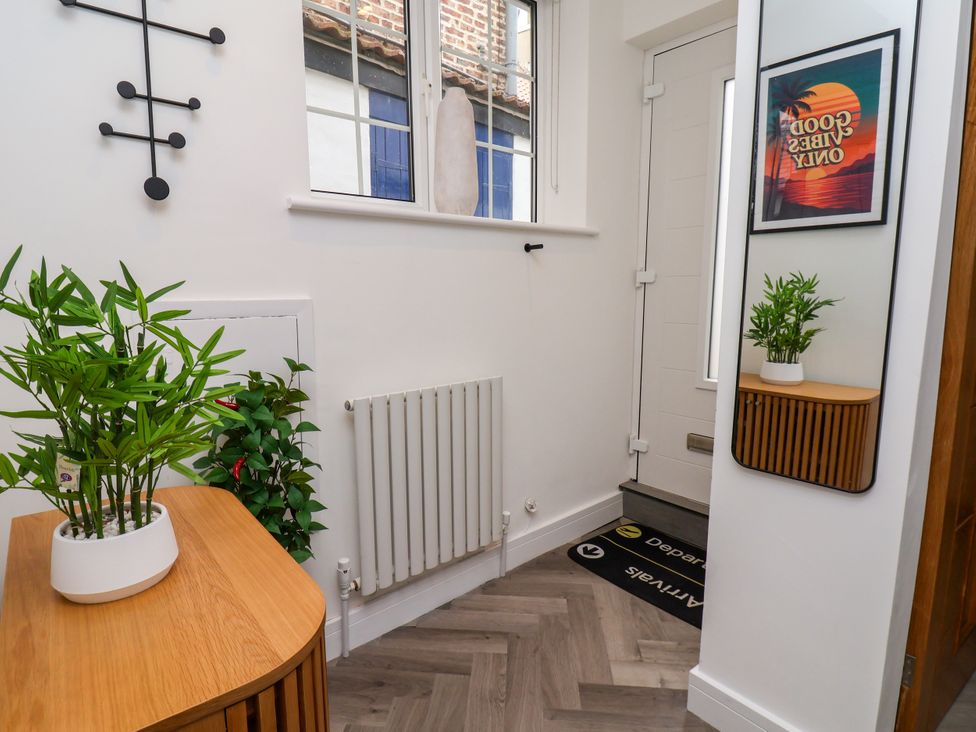 A hallway with plants and a mirror at Og's House in Whitby