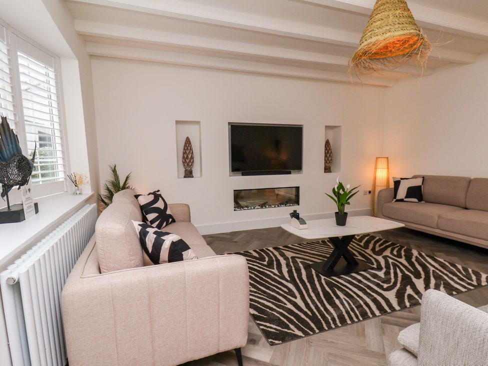 A living room with sofa and TV at Og's House in Whitby