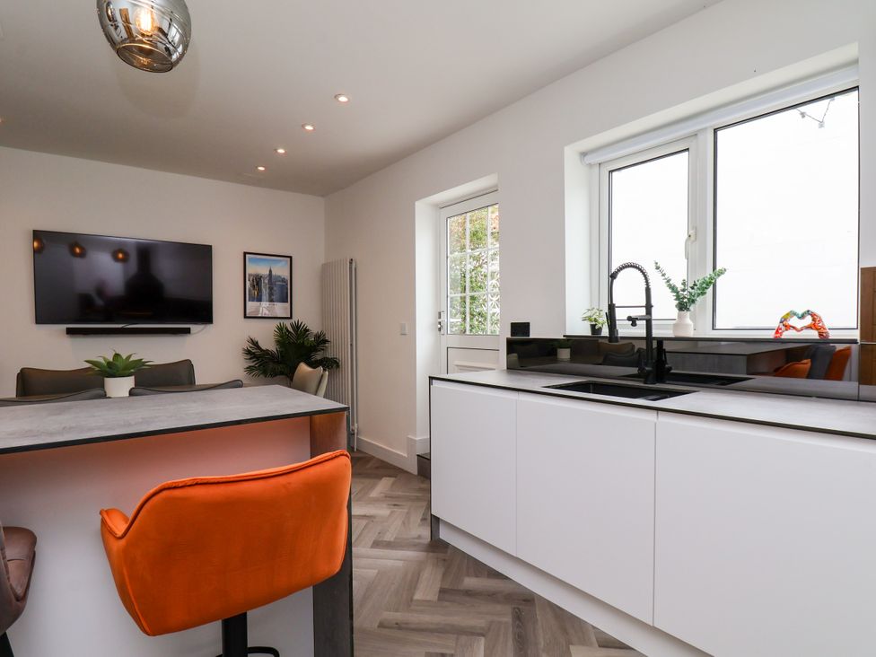 A kitchen with a television and sink at Og's House in Whitby