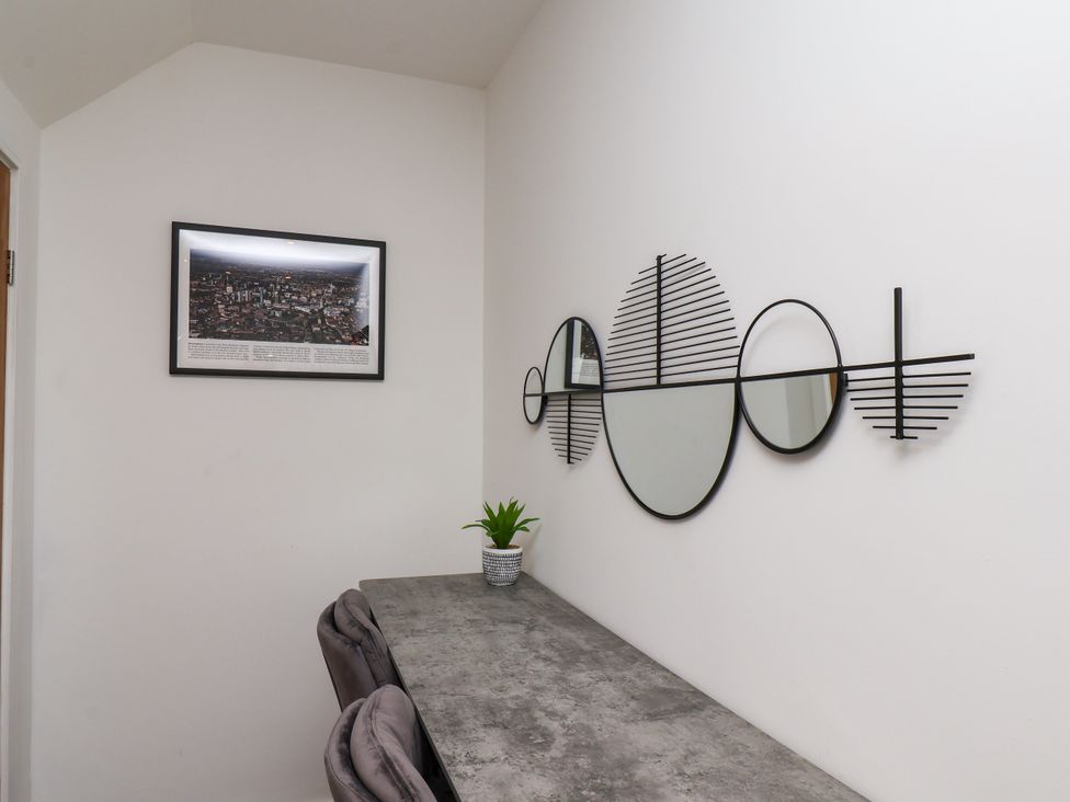 A home office with a table and decorative mirrors at Og's House in Whitby