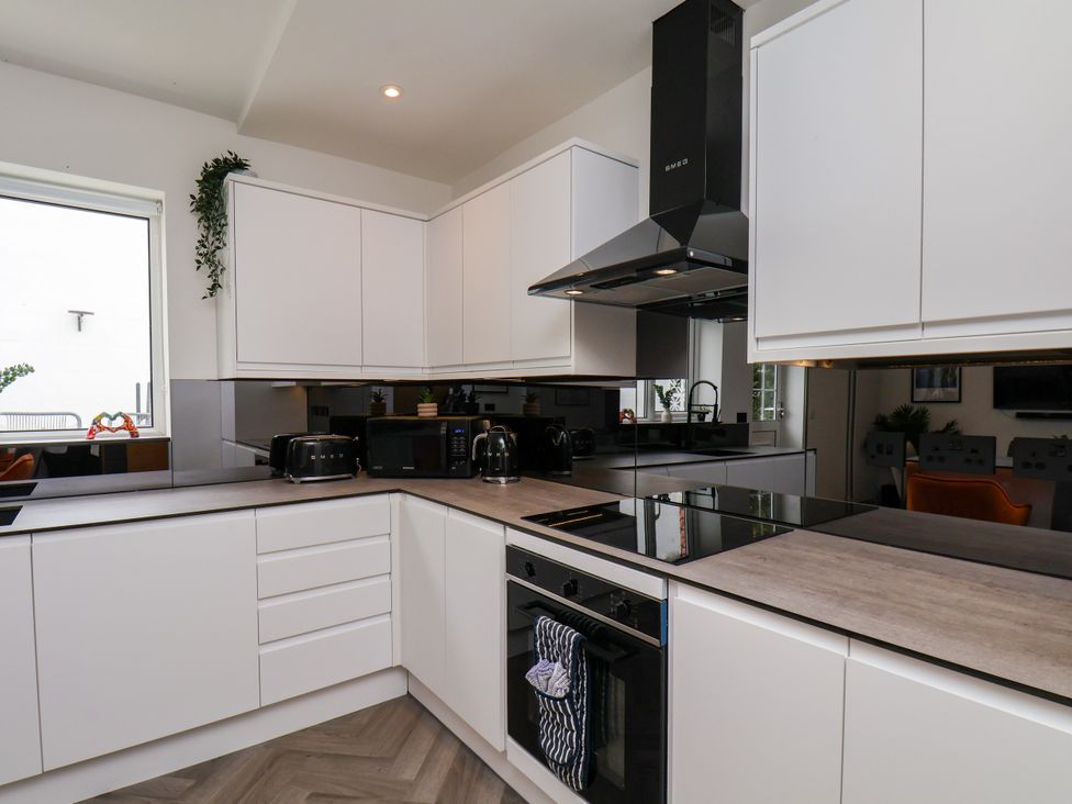 A kitchen with modern appliances and cabinetry at Og's House in Whitby