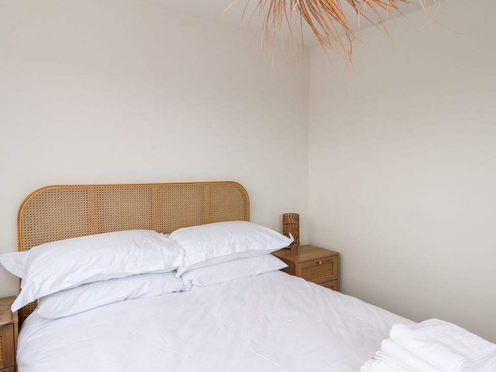 A bedroom with a bed and bedside table at Og's House in Whitby