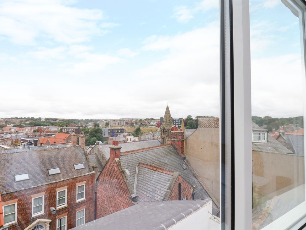 A view of rooftops and buildings from a window at Og's House in Whitby