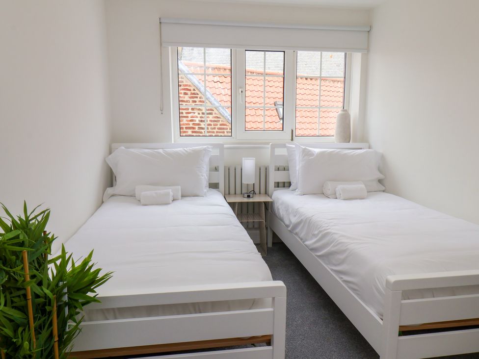 A bedroom with two single beds at Og's House in Whitby