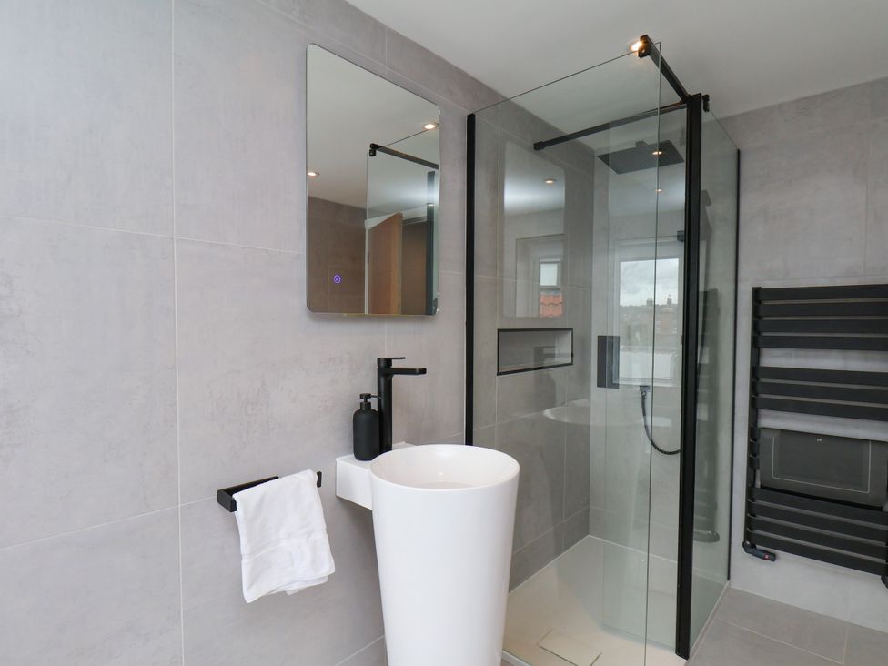 A bathroom with sink and shower at Og's House in Whitby