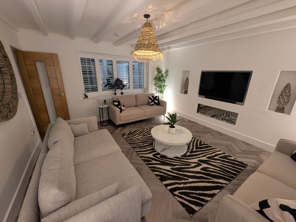 A living room with a sofa and armchair at Og's House in Whitby