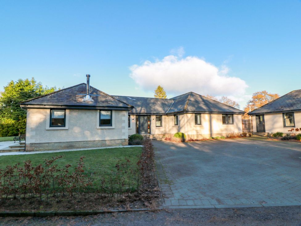 A house with a driveway and garden at Cramar Cottage in 