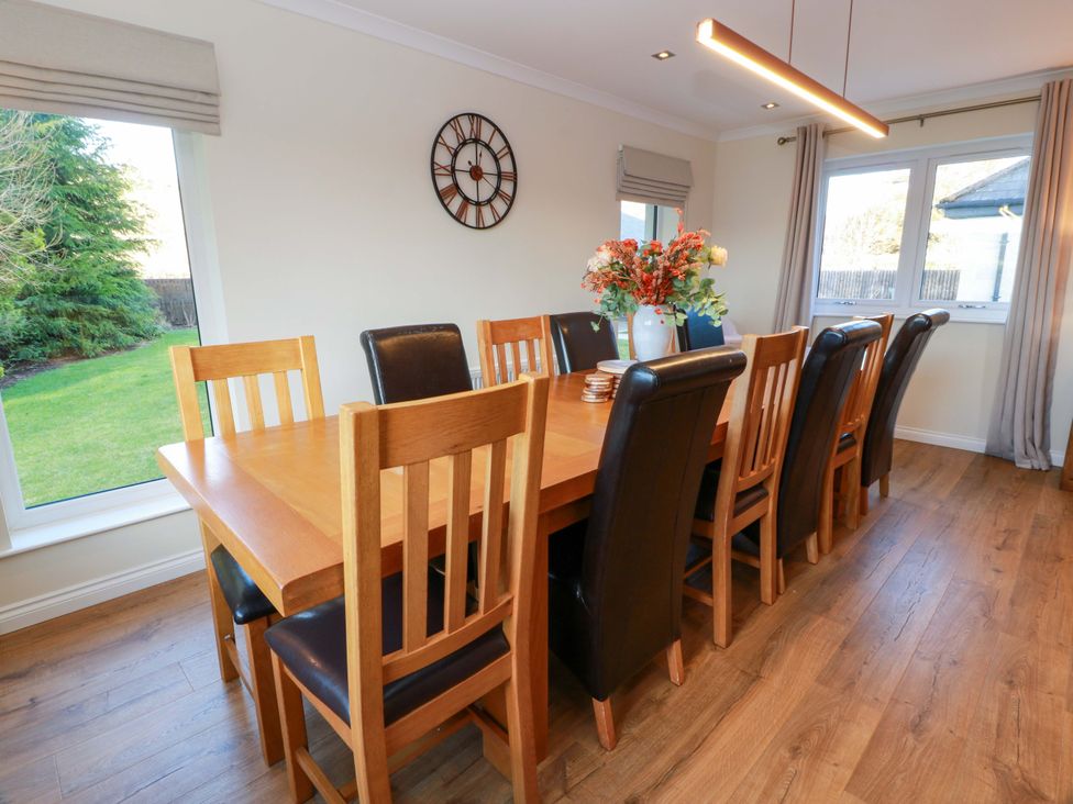 A dining room with a large table and chairs at Cramar Cottage