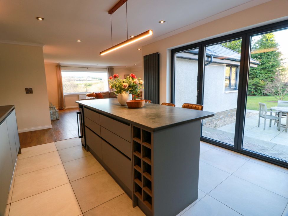A kitchen with an island and window view at Cramar Cottage