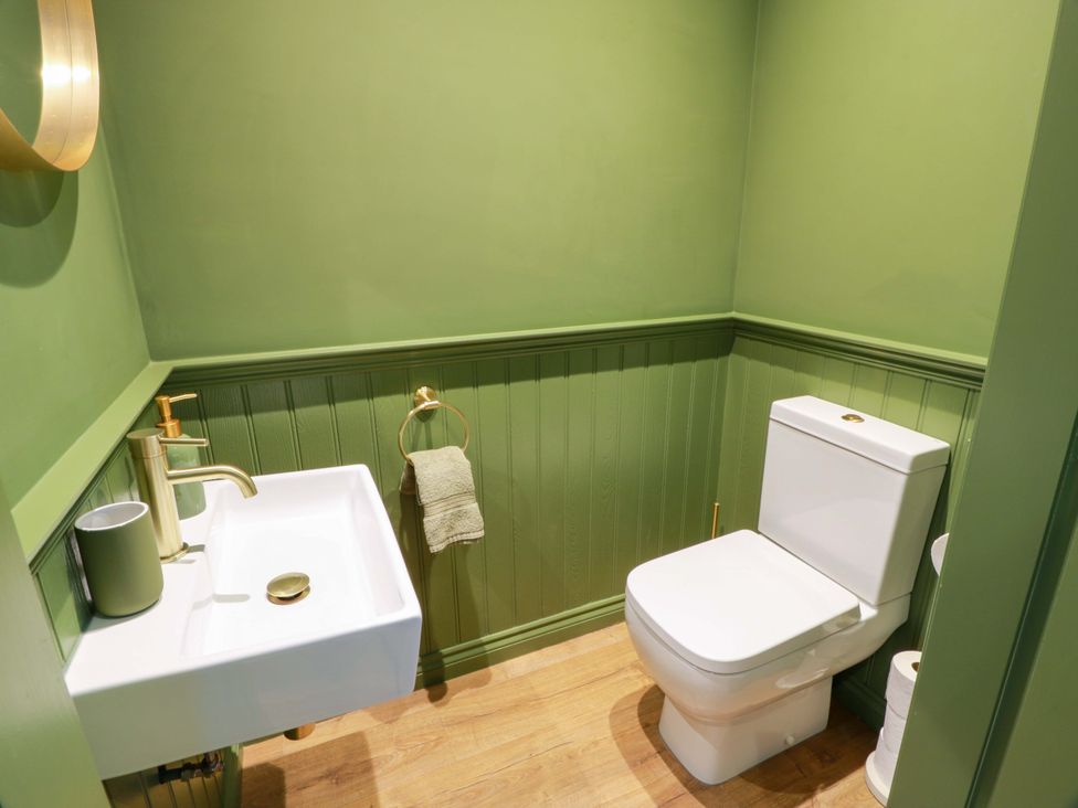 A bathroom with a toilet and sink at Cramar Cottage