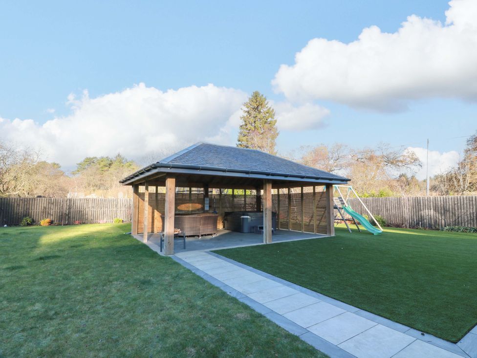 A gazebo with outdoor seating and a swing at Cramar Cottage in 