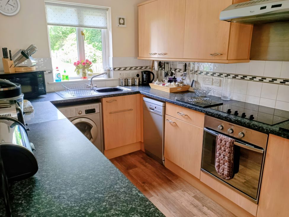 A kitchen with appliances and a window at 29 Pendra Loweth, Falmouth