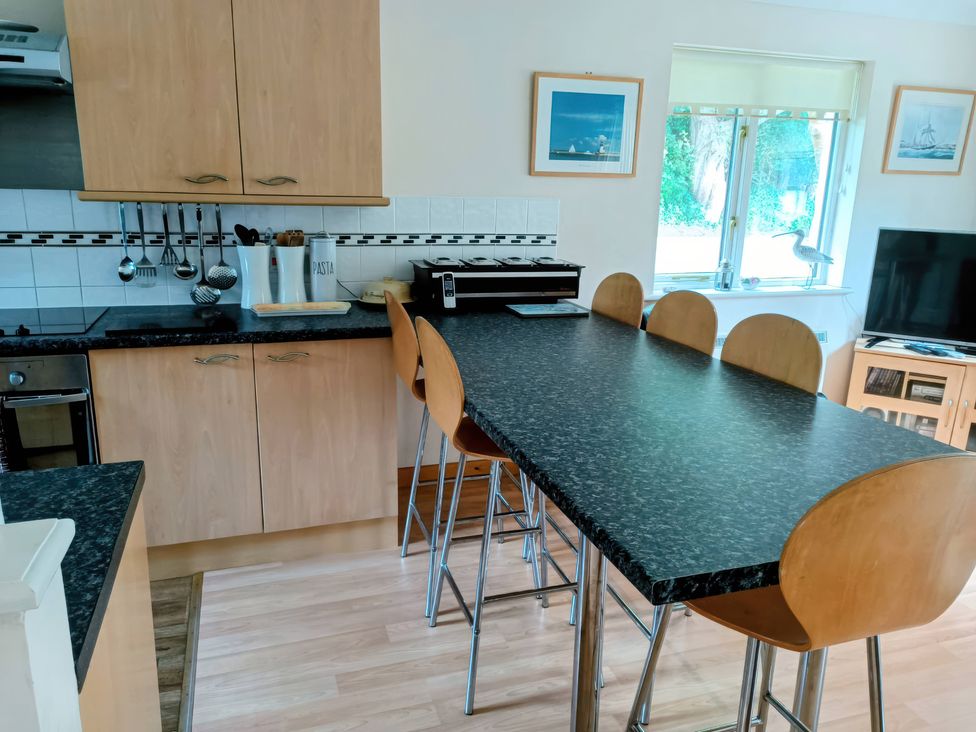 A kitchen with a countertop and bar stools at 29 Pendra Loweth Falmouth