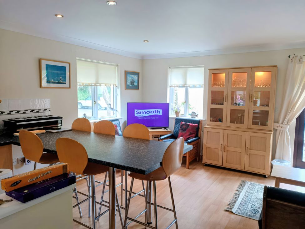 A kitchen with island seating and a television at 29 Pendra Loweth Falmouth