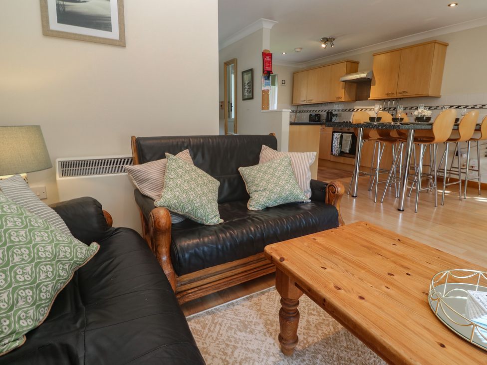 A living room with a sofa and a coffee table at Stargazy in Falmouth