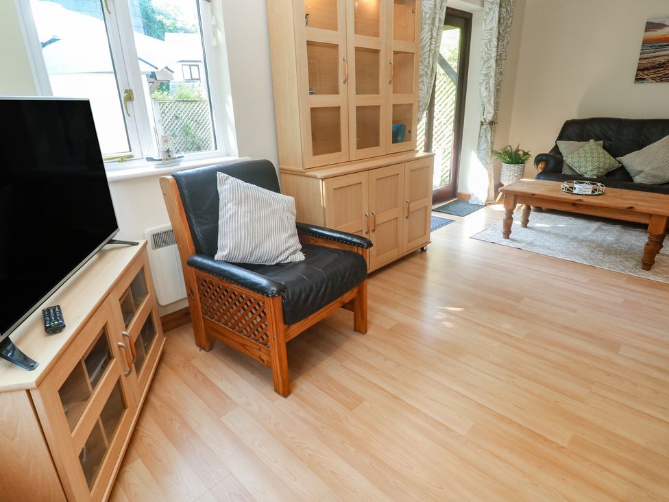 A living room with a television and sofa at Stargazy in Falmouth