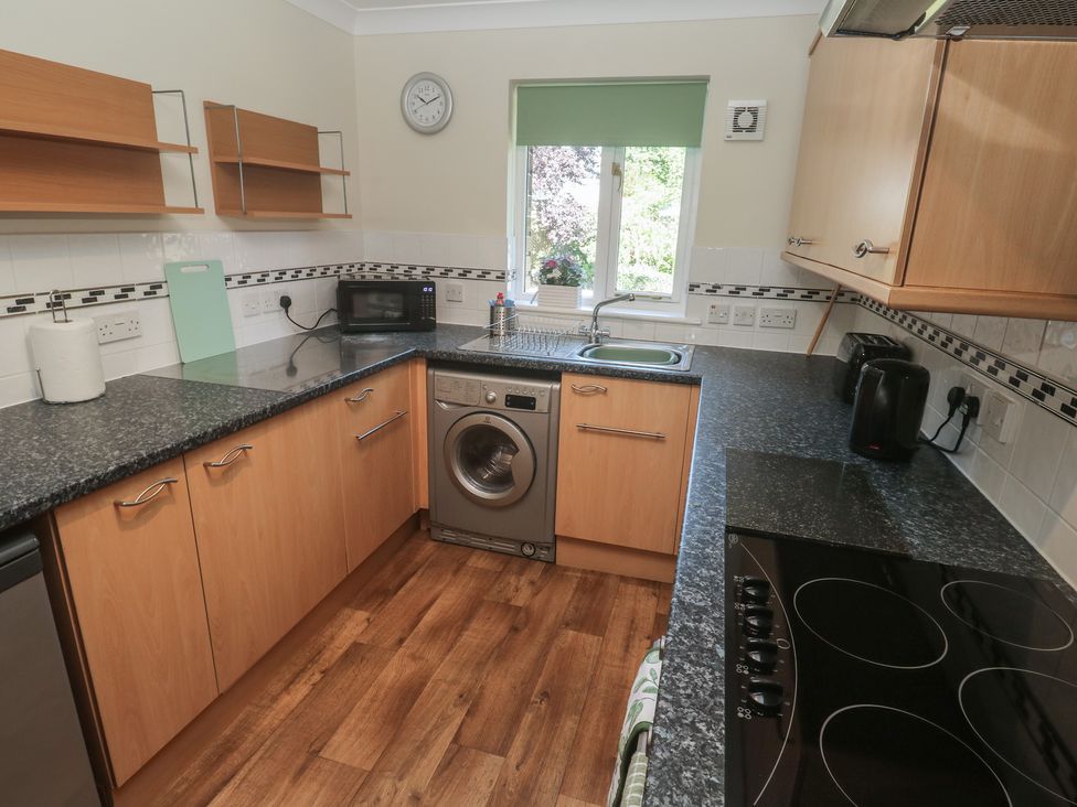 A kitchen with a microwave and cooking appliances at Stargazy in Falmouth