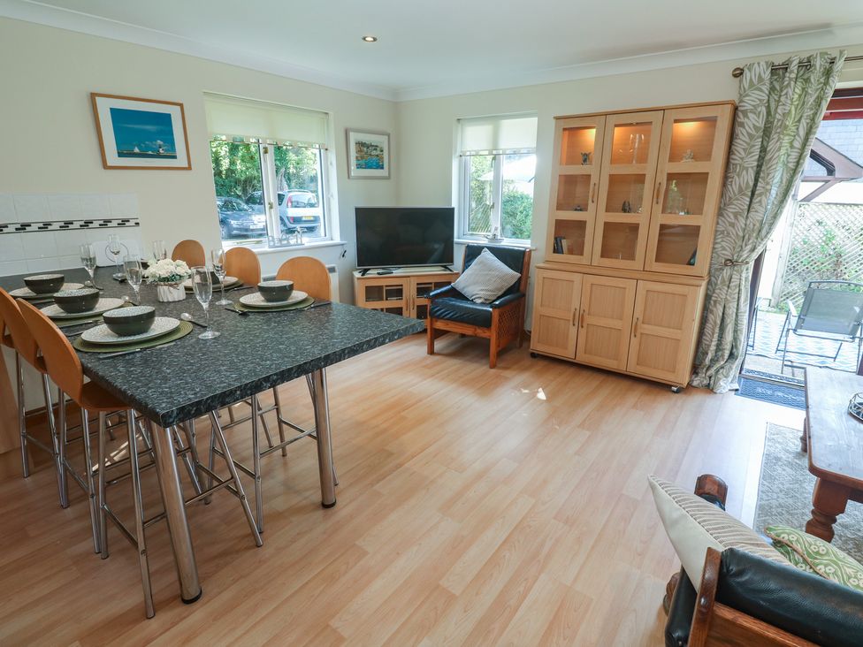 A dining room with a table and chairs at Stargazy in Falmouth